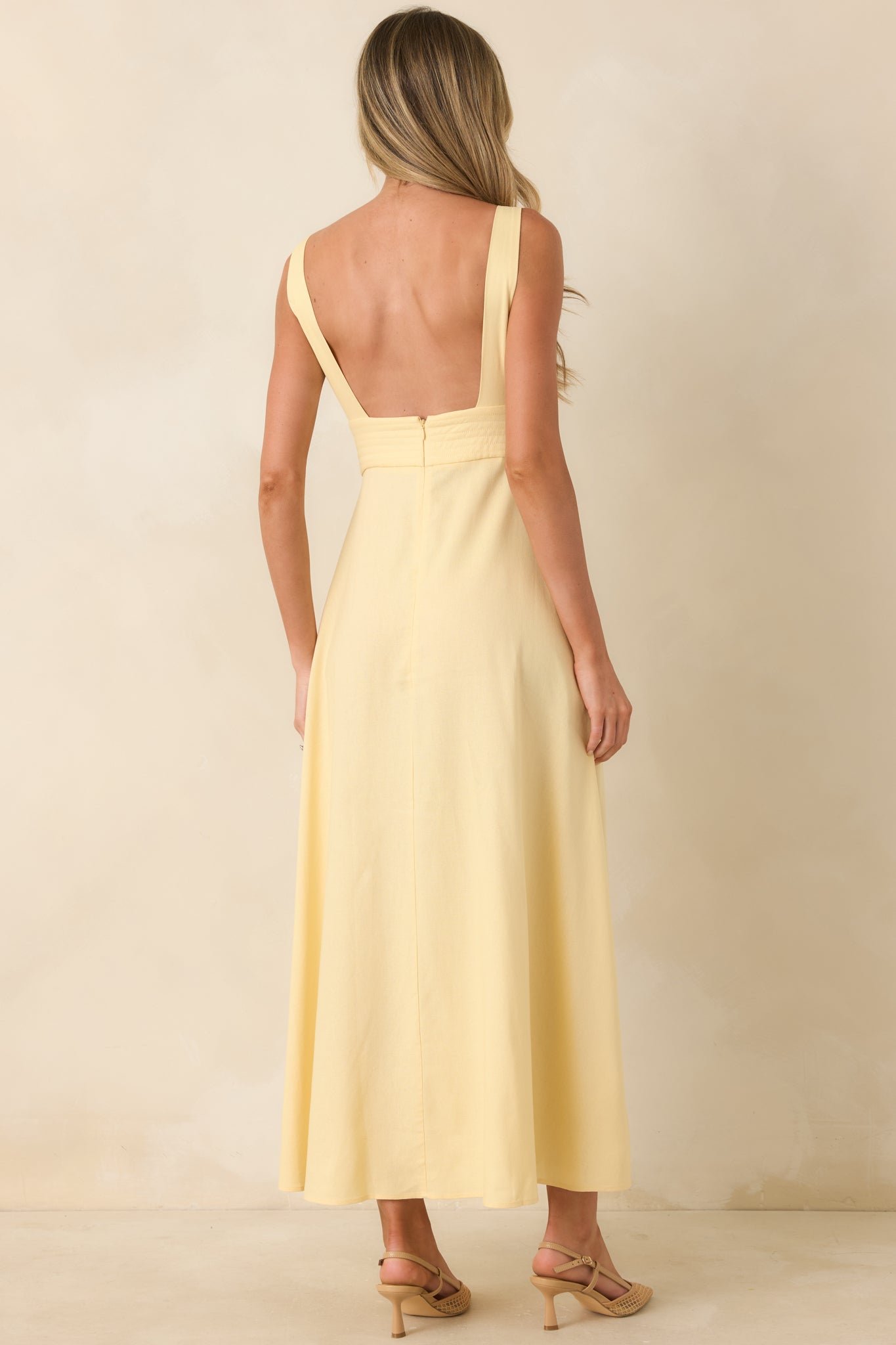 Rear view of midi dress with wide straps and full flowing skirt silhouette.