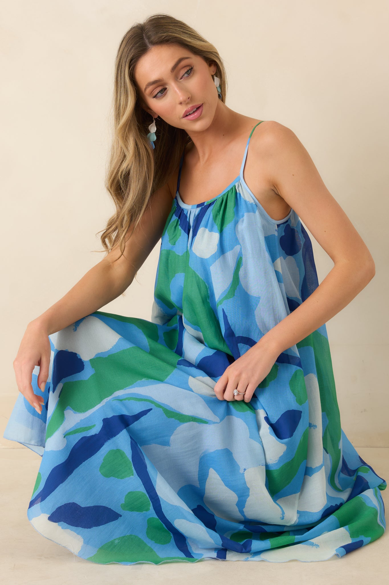 Close view of lightweight cotton-silk floral fabric with abstract blue and green print and soft drape.

