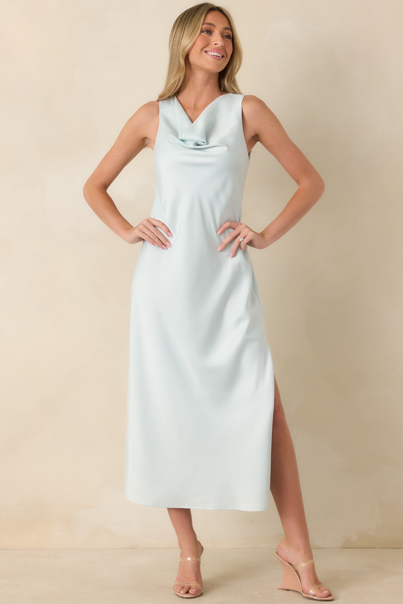 Sleek satin midi dress in sky blue with softly draped neckline and a smooth, tailored silhouette.