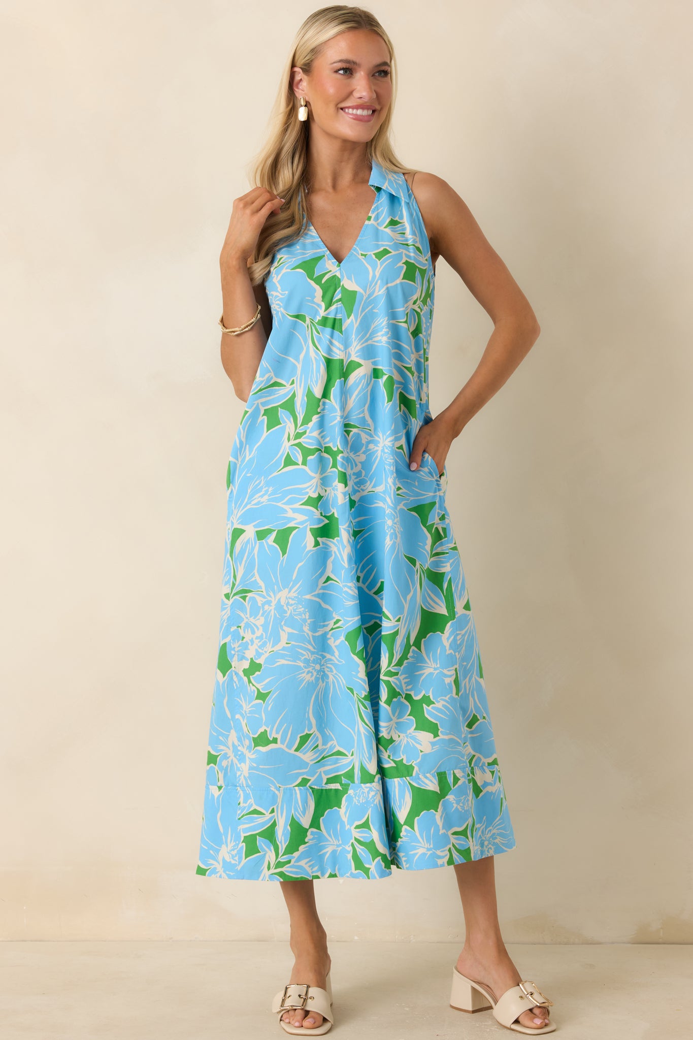 Blue and green floral print midi dress showcasing a flattering V-neck detail, crisp cotton fabric, and an easy everyday silhouette.