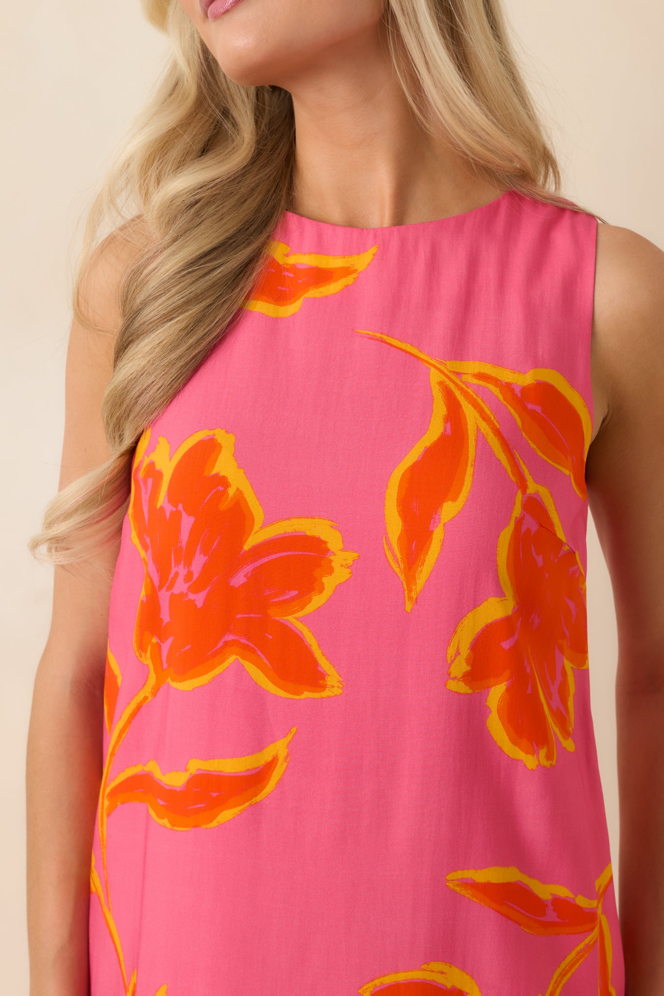 Close-up of printed fabric with soft texture and high neckline detail on lightweight mini dress.