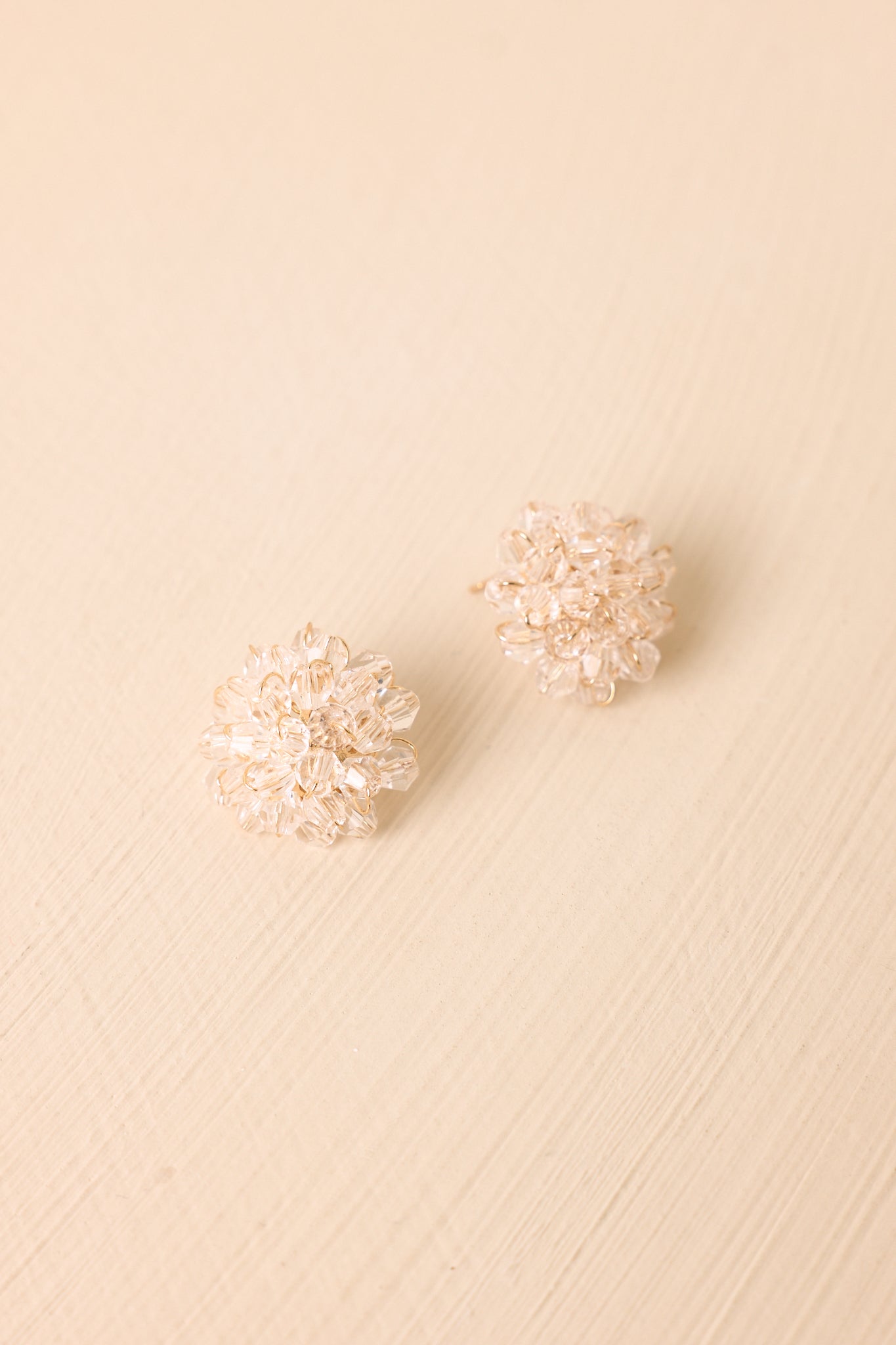 Sparkling floral earrings showcasing faceted crystal details, delicate construction, and a polished statement design.