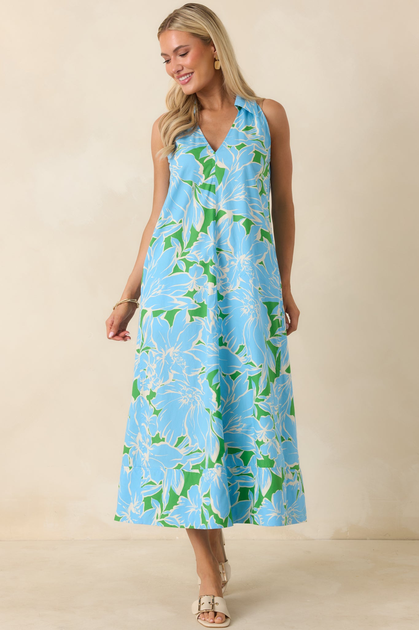 Cotton midi dress in a blue, green, and white floral print featuring a pull-on design, structured collar, and flowy hemline.