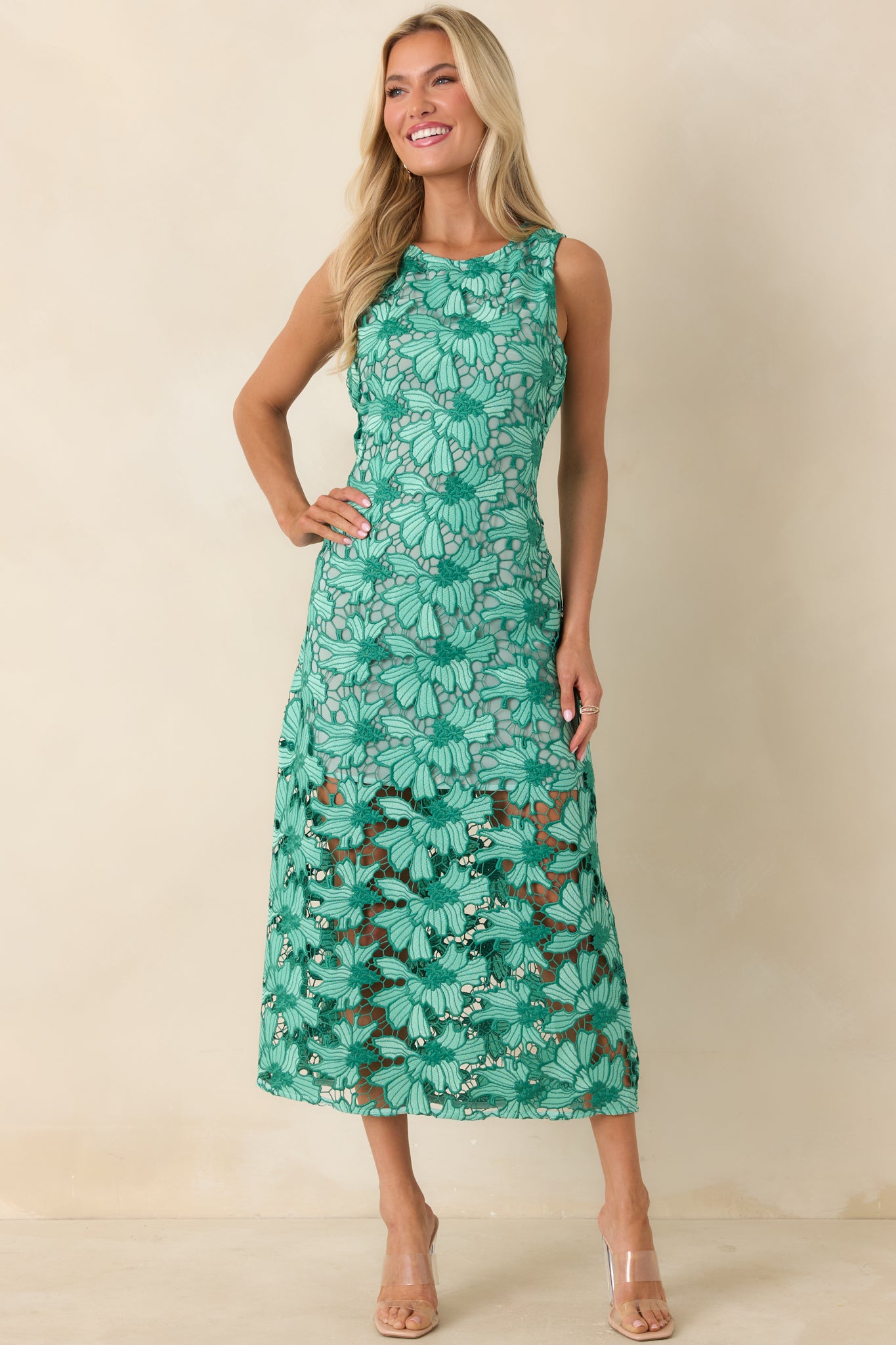 Fitted lace midi dress featuring intricate floral overlay and streamlined silhouette.