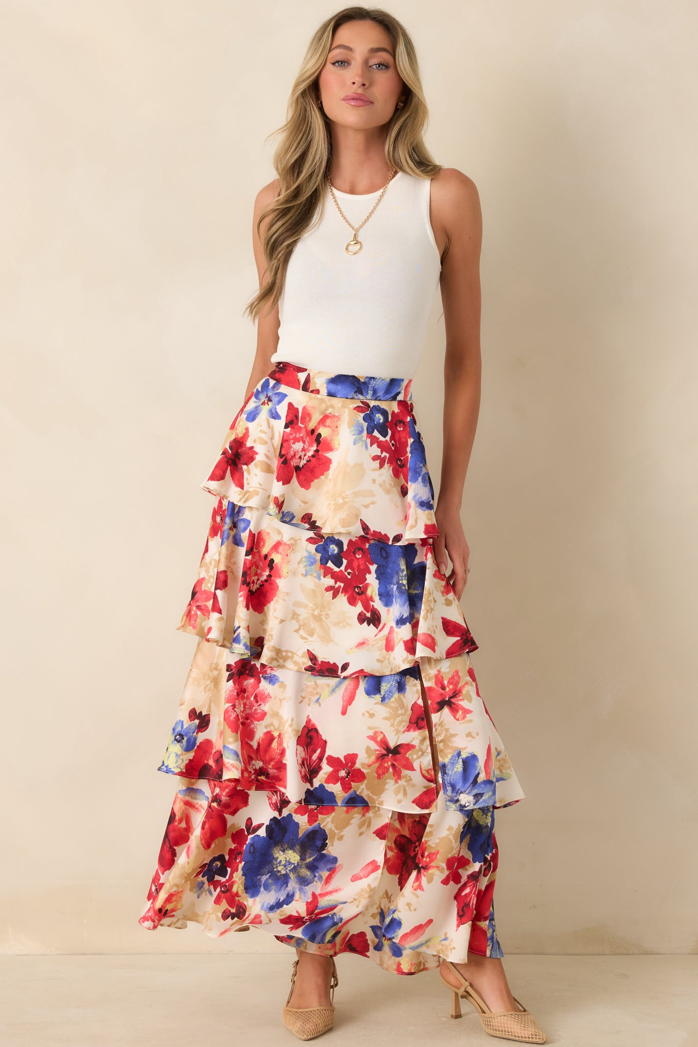 Ivory and red floral print maxi skirt with tiered layers and a flowing, full silhouette.