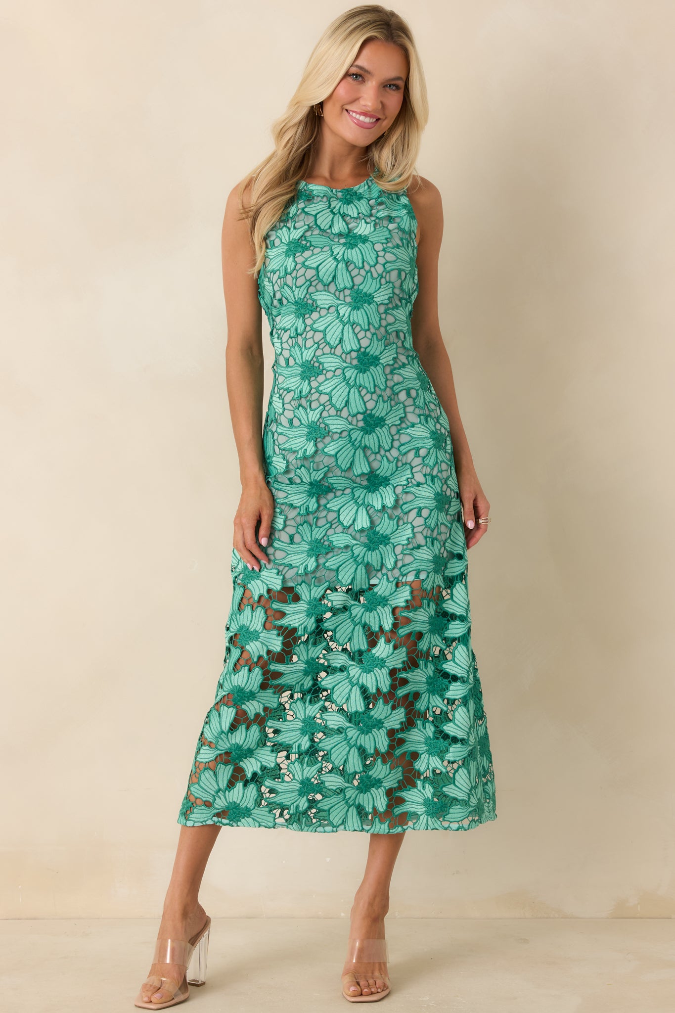 Green floral lace midi dress with sleeveless design and high neckline.