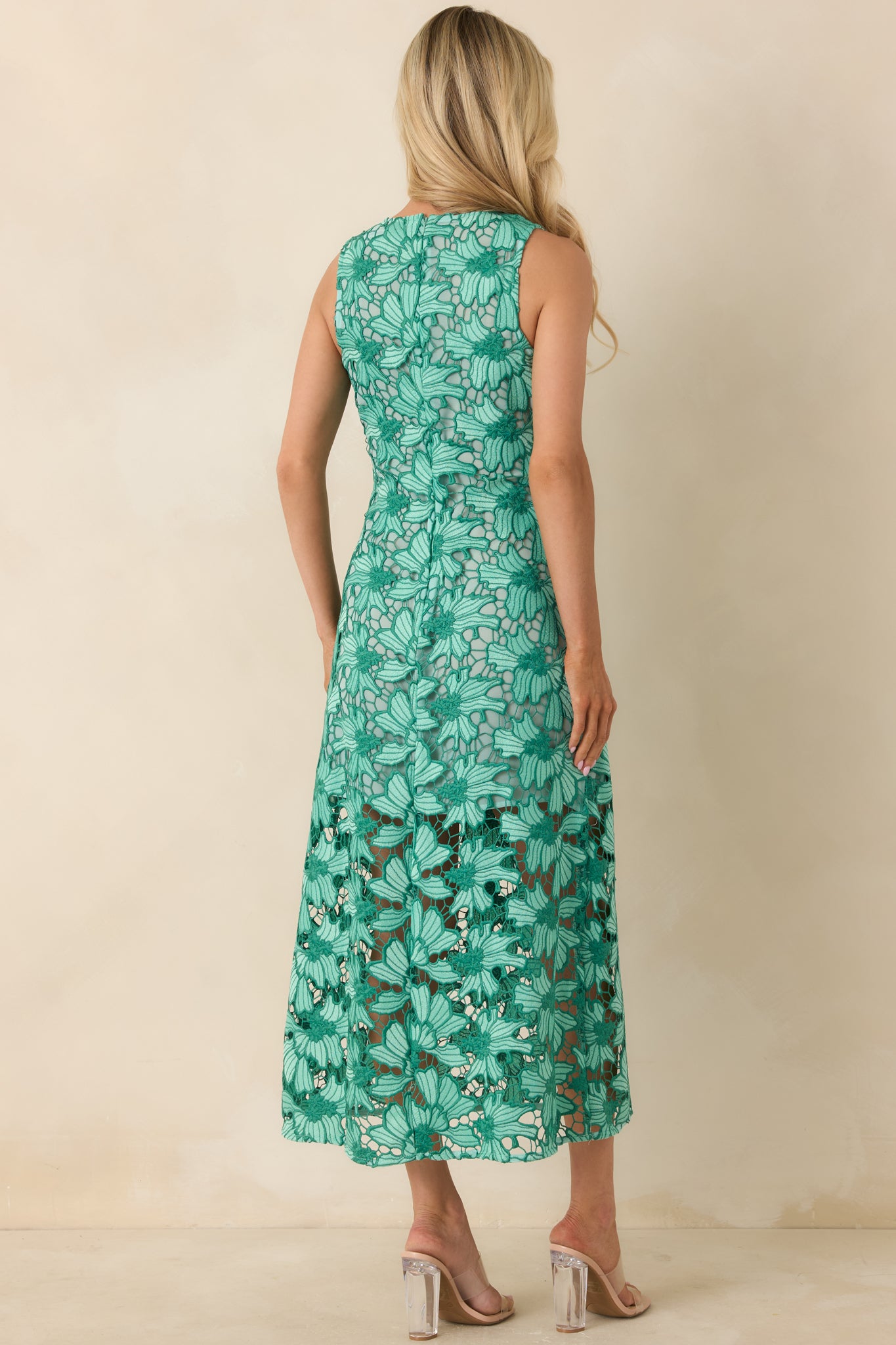 Rear view of green lace midi dress with high neckline and fitted silhouette.
