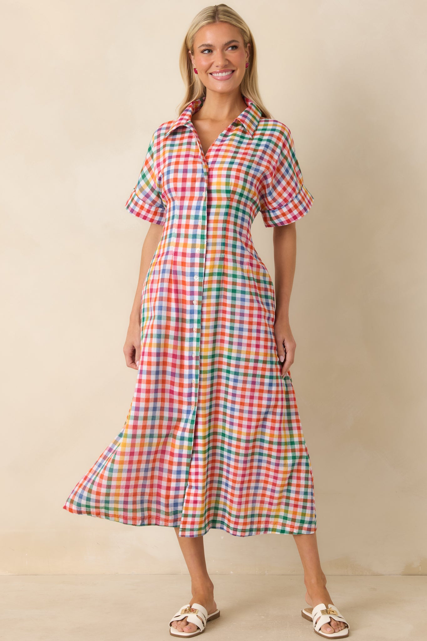 Multi color plaid midi dress with functional front buttons, side pockets, and breezy cotton design.