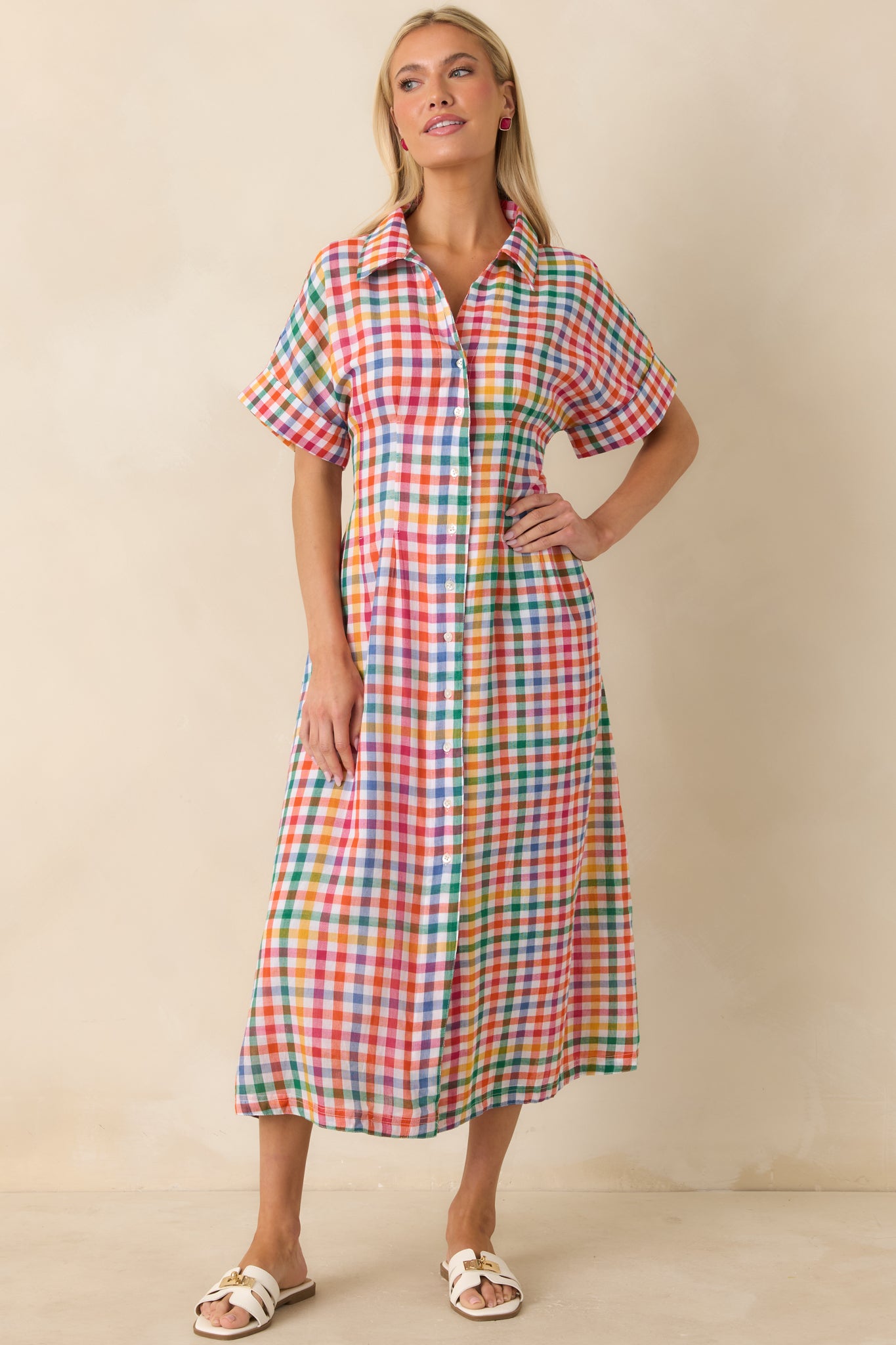 Lightweight plaid shirt dress with collared neckline, cuffed sleeves, and flattering midi-length silhouette.