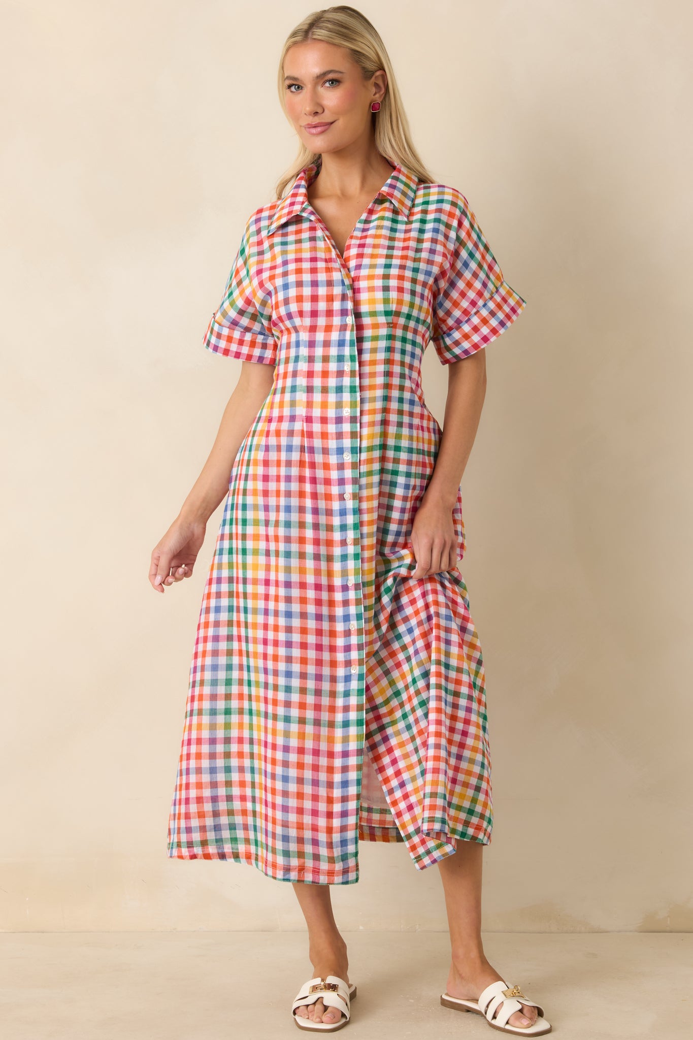 Cotton plaid midi dress featuring an elasticized back waist and classic button-front styling.