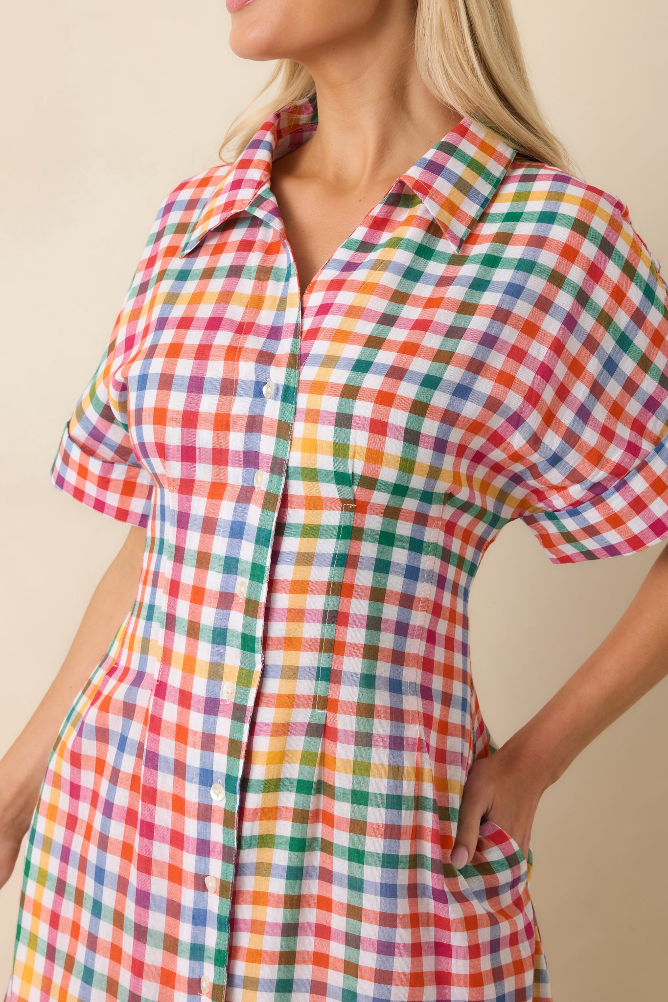 Detailed view of the multi plaid pattern, button front closure, and cuffed sleeve detail on the midi dress.