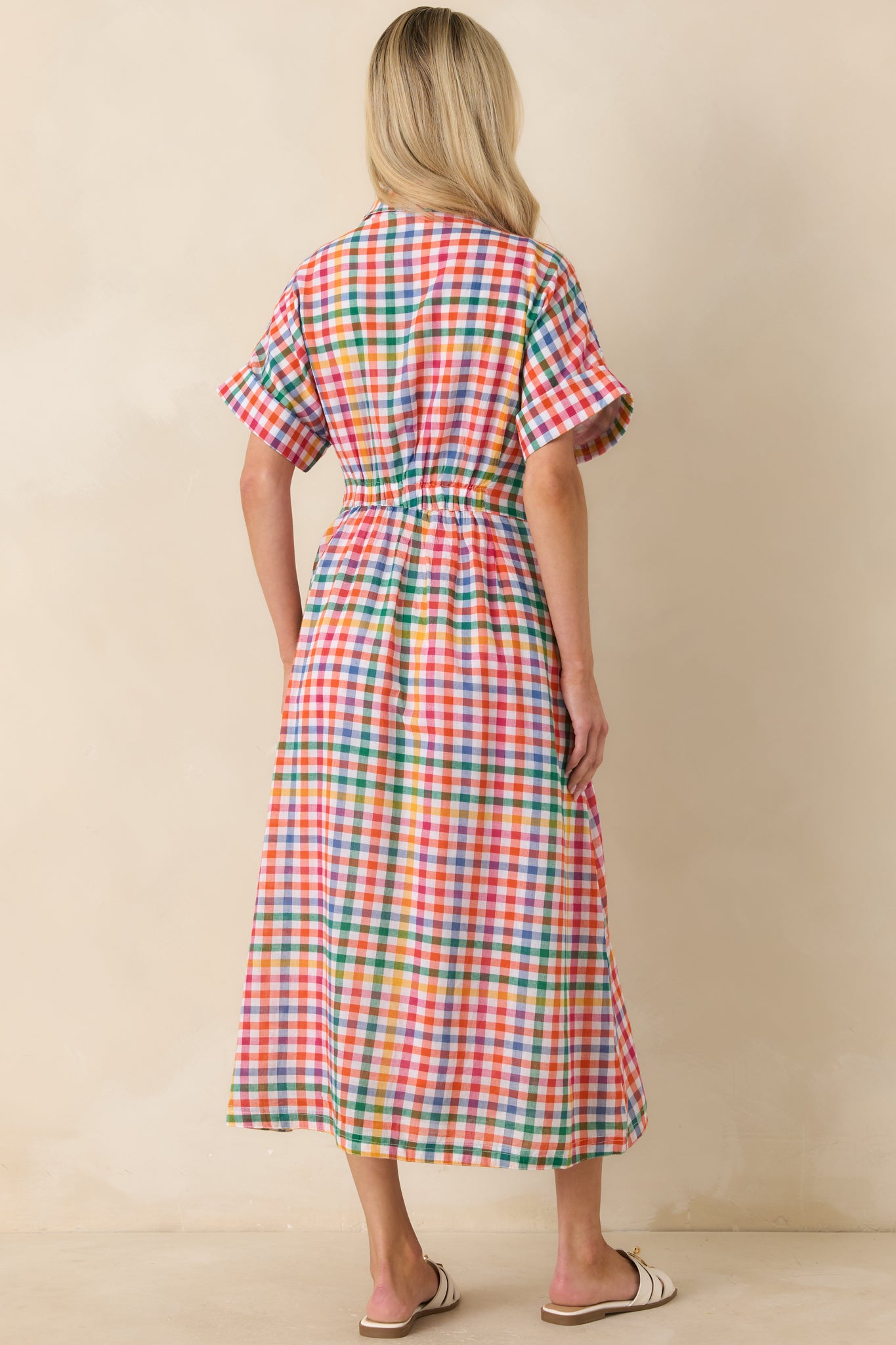 Rear view of the multi plaid cotton midi dress featuring an elastic back waist and flowing silhouette.

