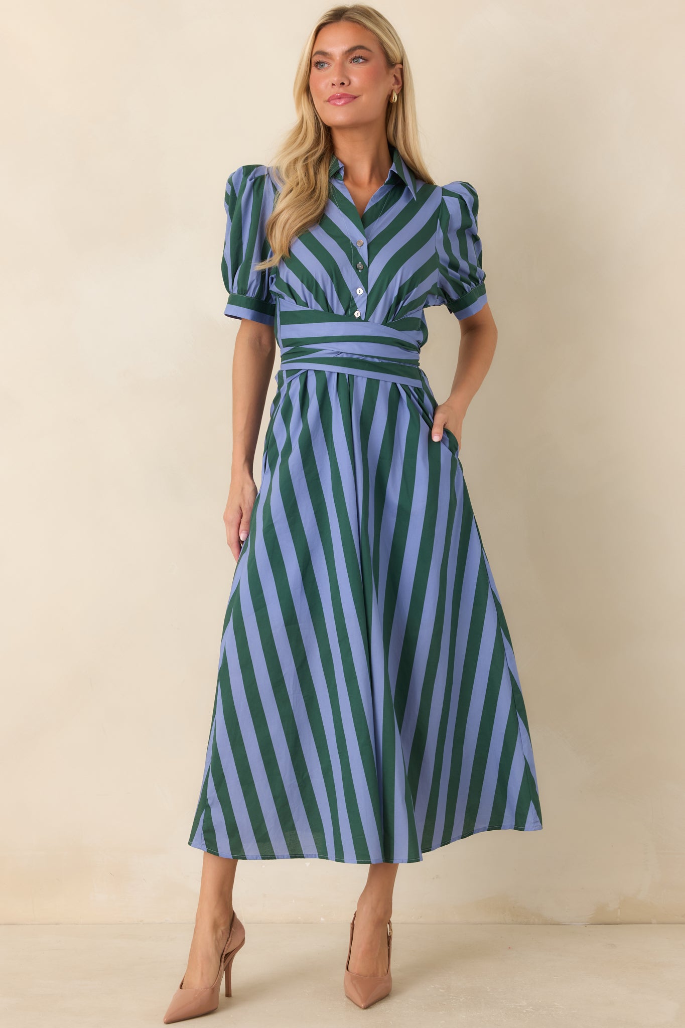 Collared blue and green striped midi dress crafted from 100% cotton, showcasing a wrap-style waist sash, functional front buttons, and a softly gathered skirt with fluid movement.