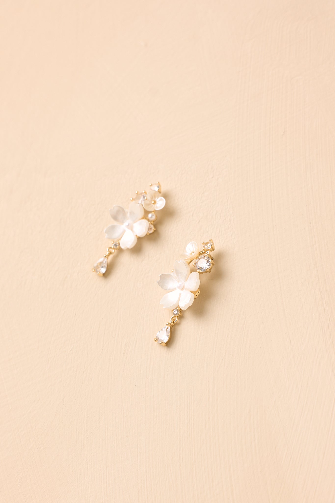 Elegant flower earrings showcasing luminous pearlescent finishes, decorative crystals, and a refined lightweight design.