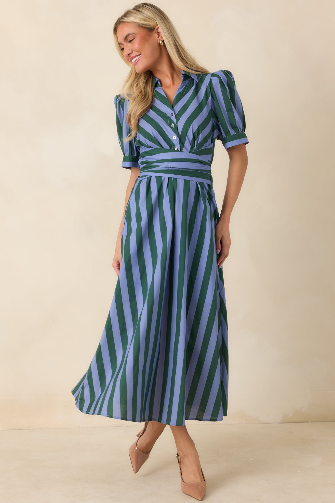 Cotton midi dress with alternating blue and green stripes, a structured collar, button-front closure, puffed short sleeves, and a full silhouette finished with a coordinating waist tie.