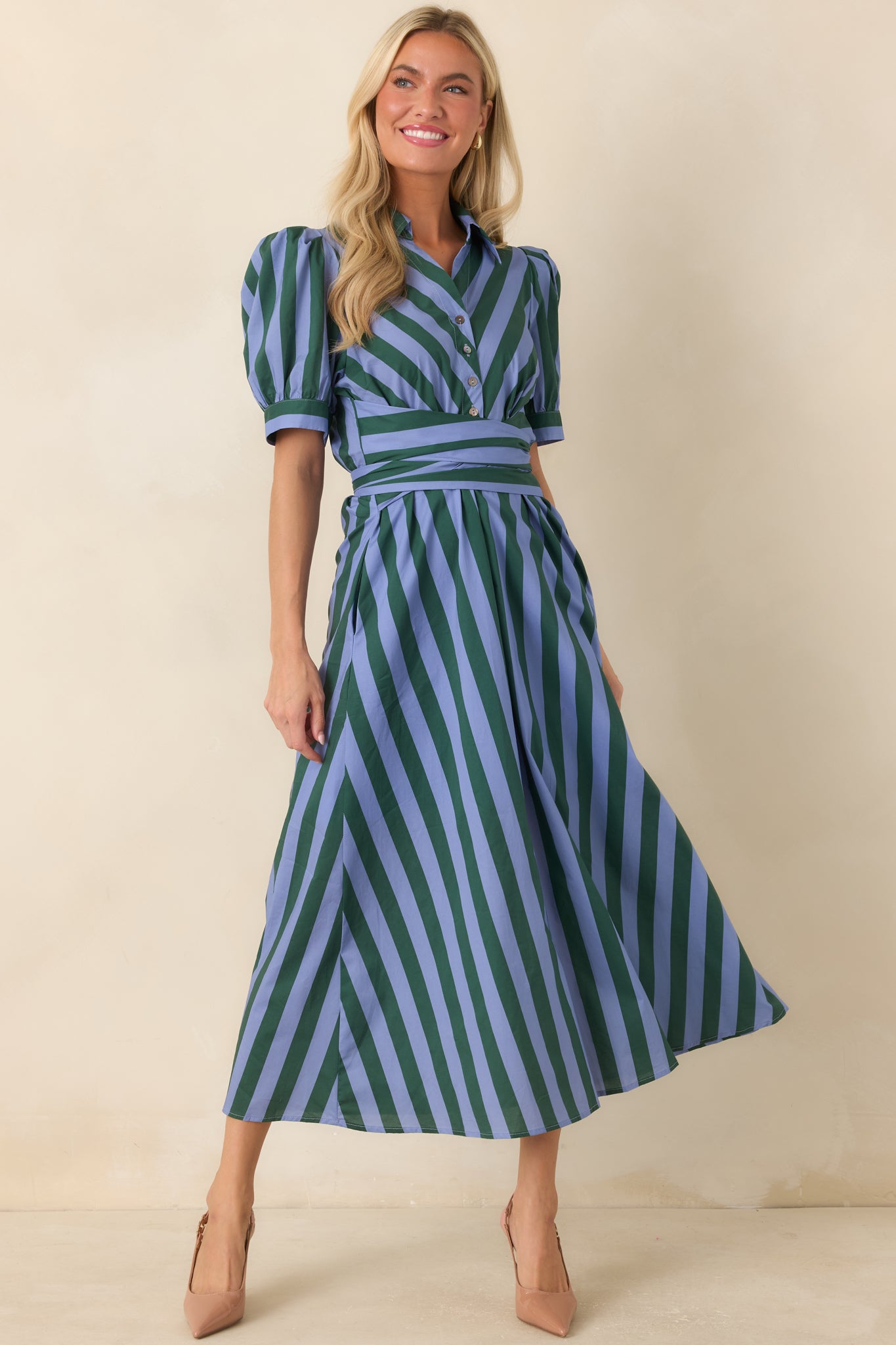 Striped cotton midi dress featuring directional blue and green paneling across the bodice, a collared button-front design, short puff sleeves, and a full skirt with side pockets.