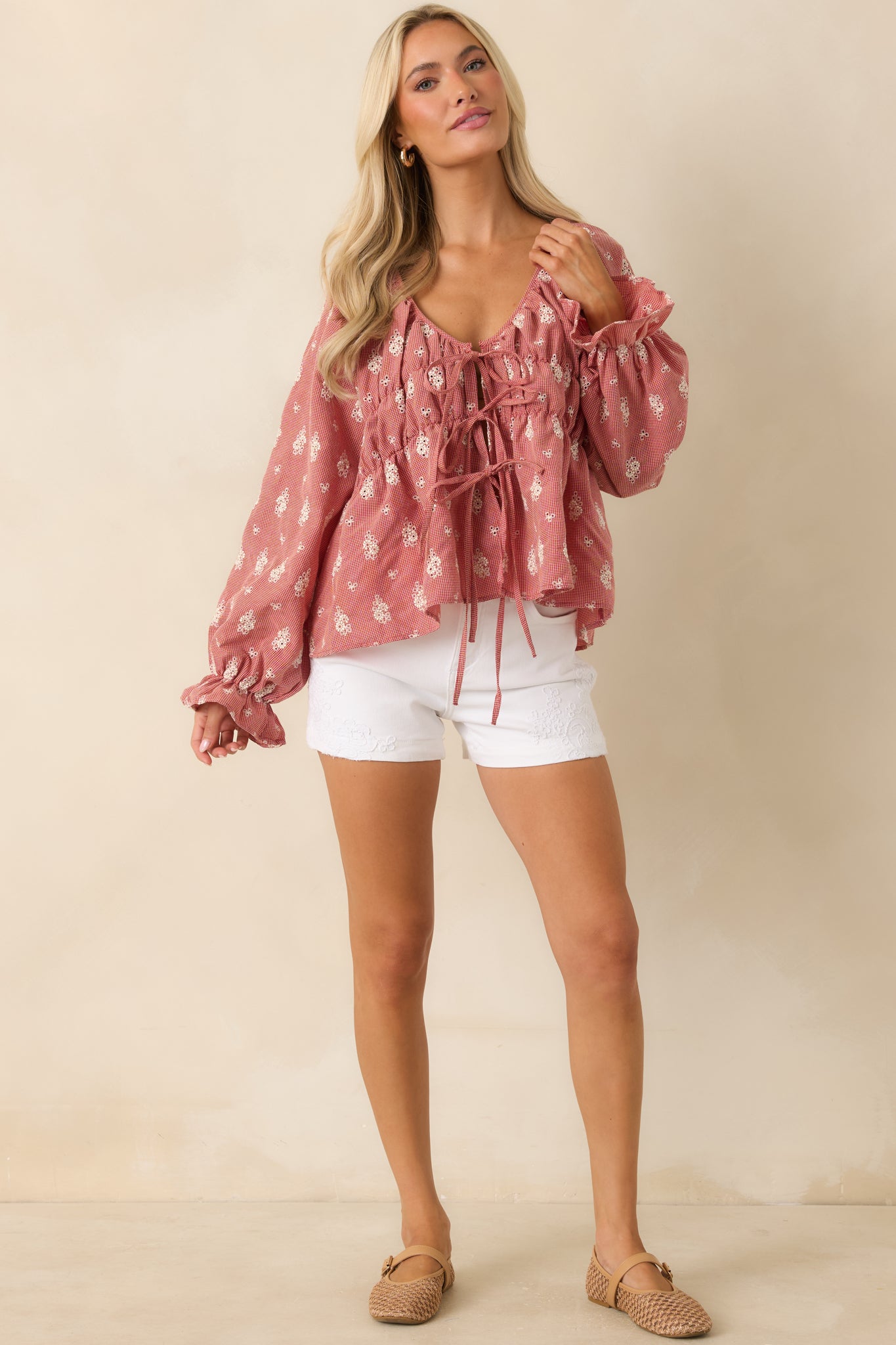 Lightweight red cotton blouse featuring an airy fit and delicate floral pattern throughout.