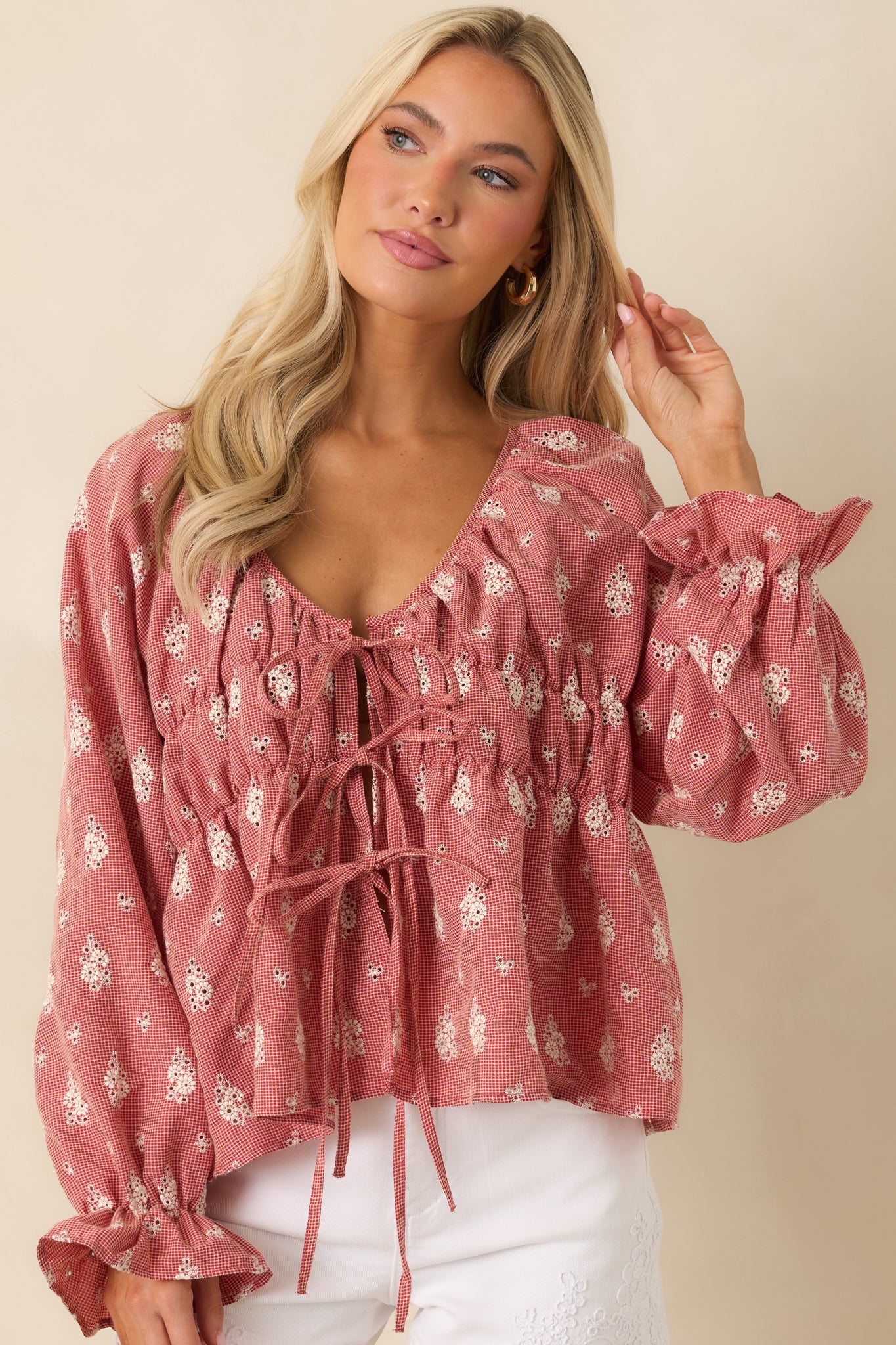 Close view of red blouse highlighting the gathered neckline and vintage floral print.