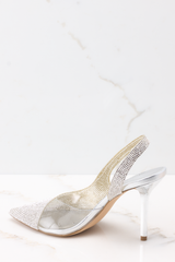 Inner-side view of these heels that feature a pointed toe, rhinestone embellishments, a clear strap on the inside, and a non-adjustable back strap.