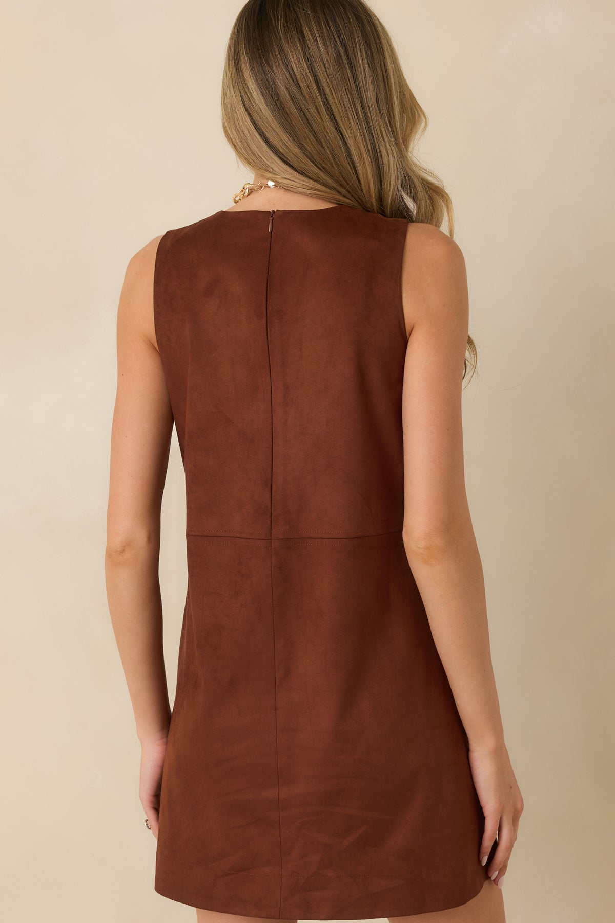 Rear view of the brown faux suede mini dress featuring a concealed back zipper and a gently flared skirt.