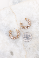 Gold rhinestone open hoop earrings compared to quarter for actual size. Earrings measure 1