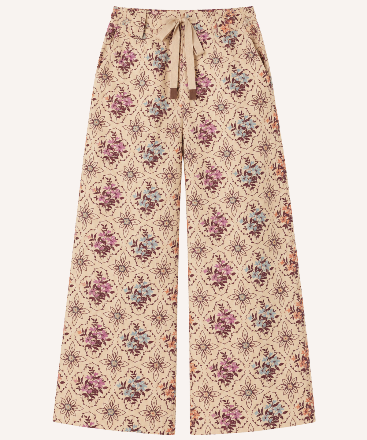 Wide-leg trousers with a beige base and an all-over floral and geometric print in dusty pink, purple, and muted blue, featuring a matching drawstring waist.