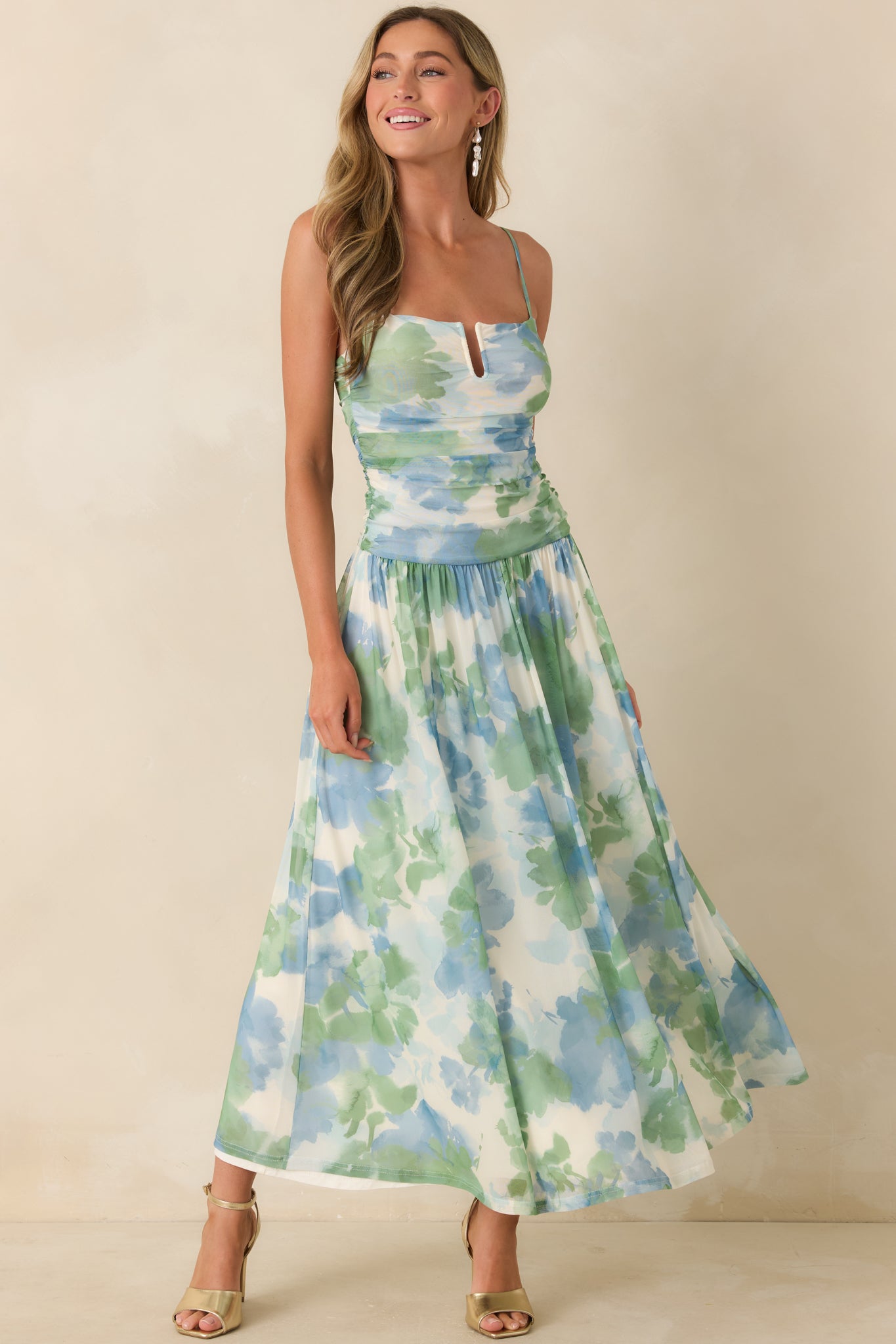 Airy mesh maxi dress featuring soft watercolor print, adjustable straps, and fluid silhouette.