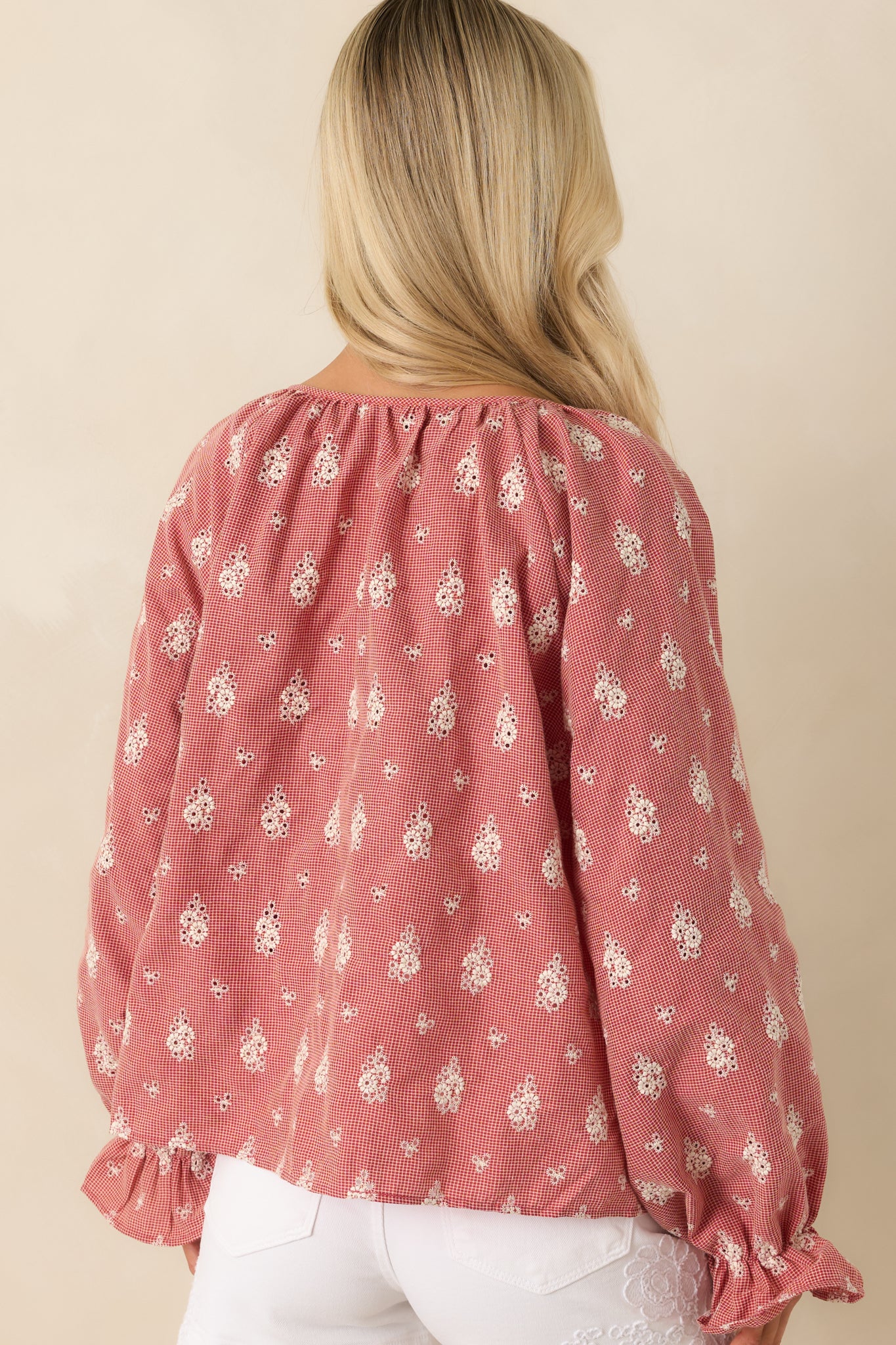 Rear view of red blouse featuring long balloon sleeves, lightweight construction, and relaxed fit silhouette.