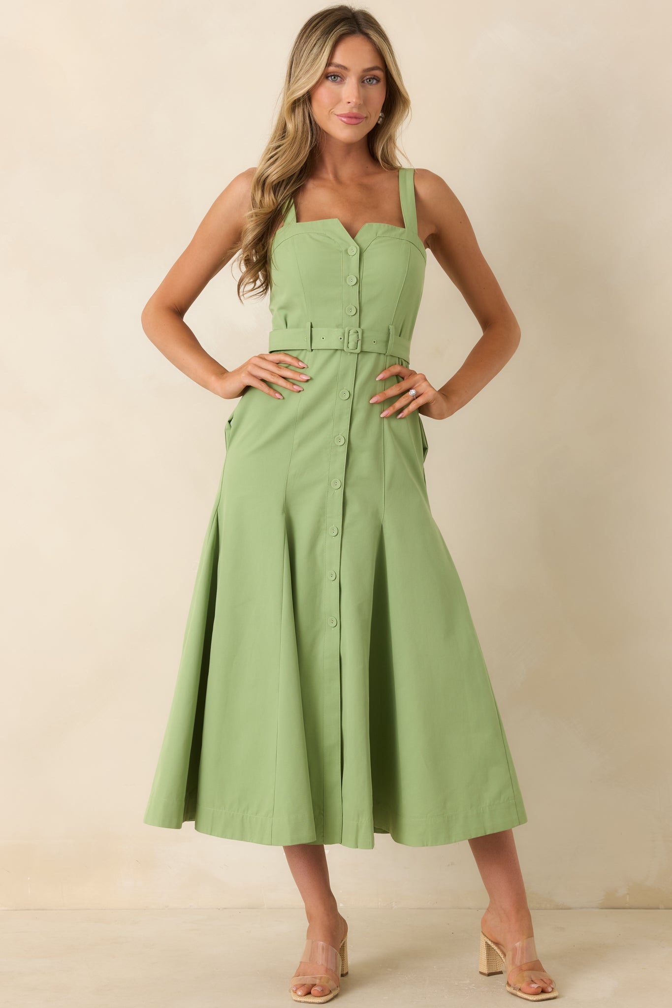 Green midi dress in a cotton blend fabric featuring a structured sweetheart-inspired neckline, wide shoulder straps, and a flowy skirt.