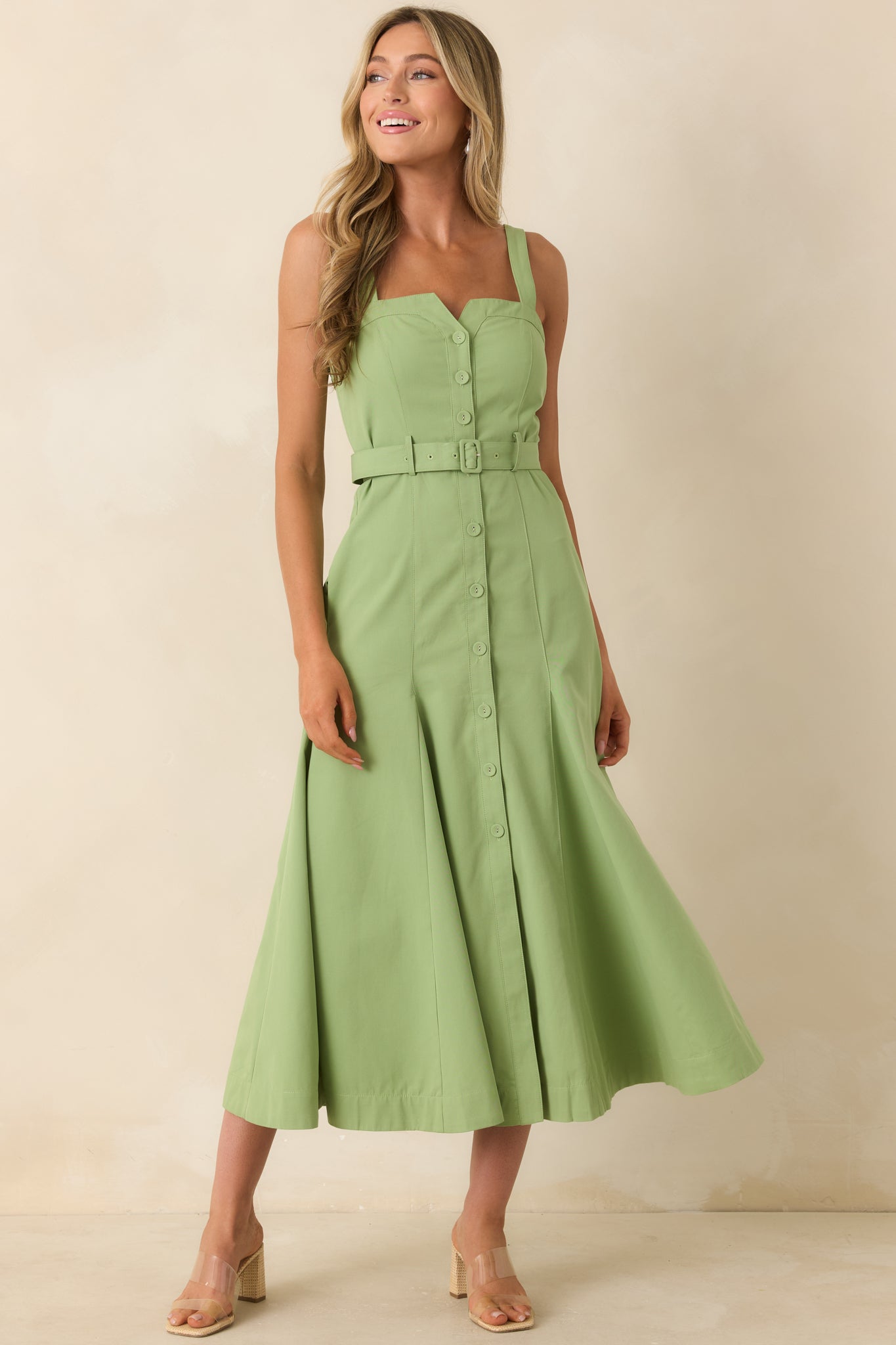 Button-front green midi dress showcasing a matching adjustable belt and a softly flared midi-length silhouette.