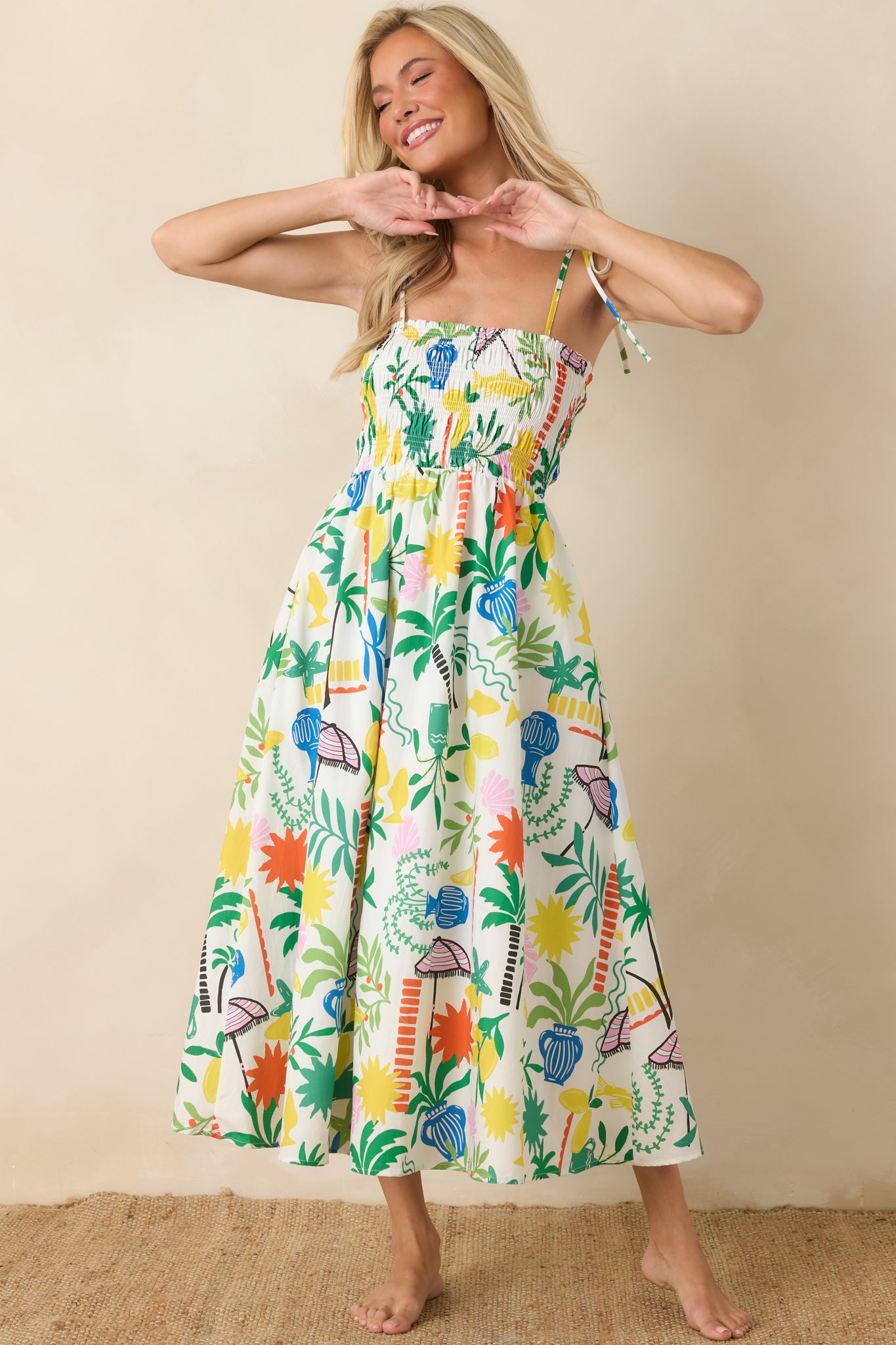 Smocked bodice midi dress featuring a relaxed fit through the skirt, airy cotton fabric, and whimsical resort-inspired print.