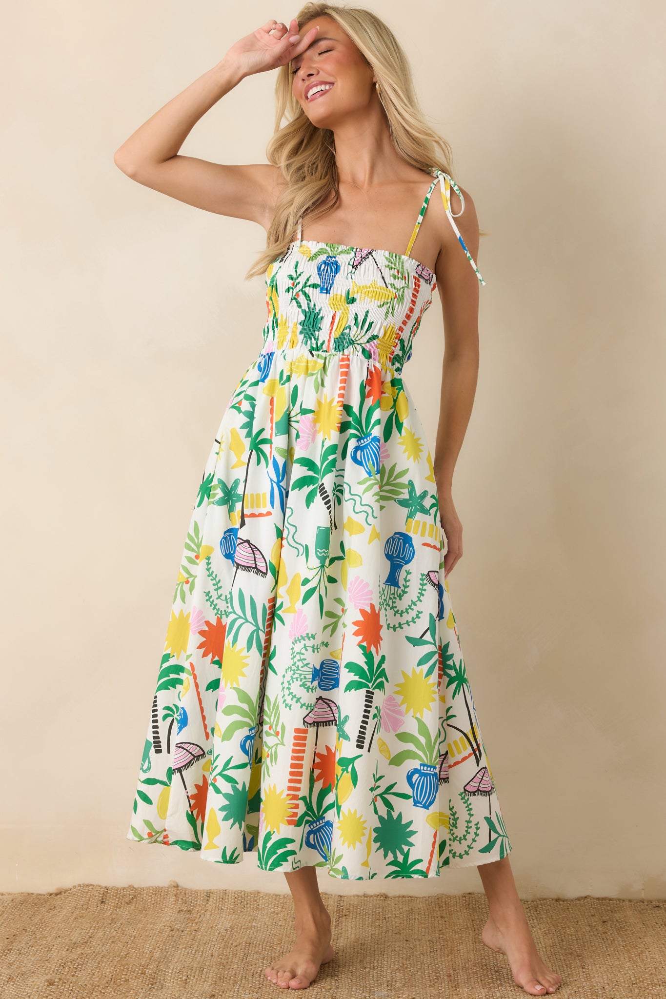 Full-length view of a white multi midi dress with shoulder ties, gathered waist detailing, and a breezy, comfortable drape.