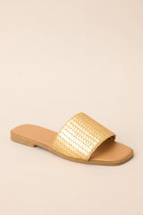 Inner-side view of these sandals that feature a gold detailed strap over the foot and a slip-on style.