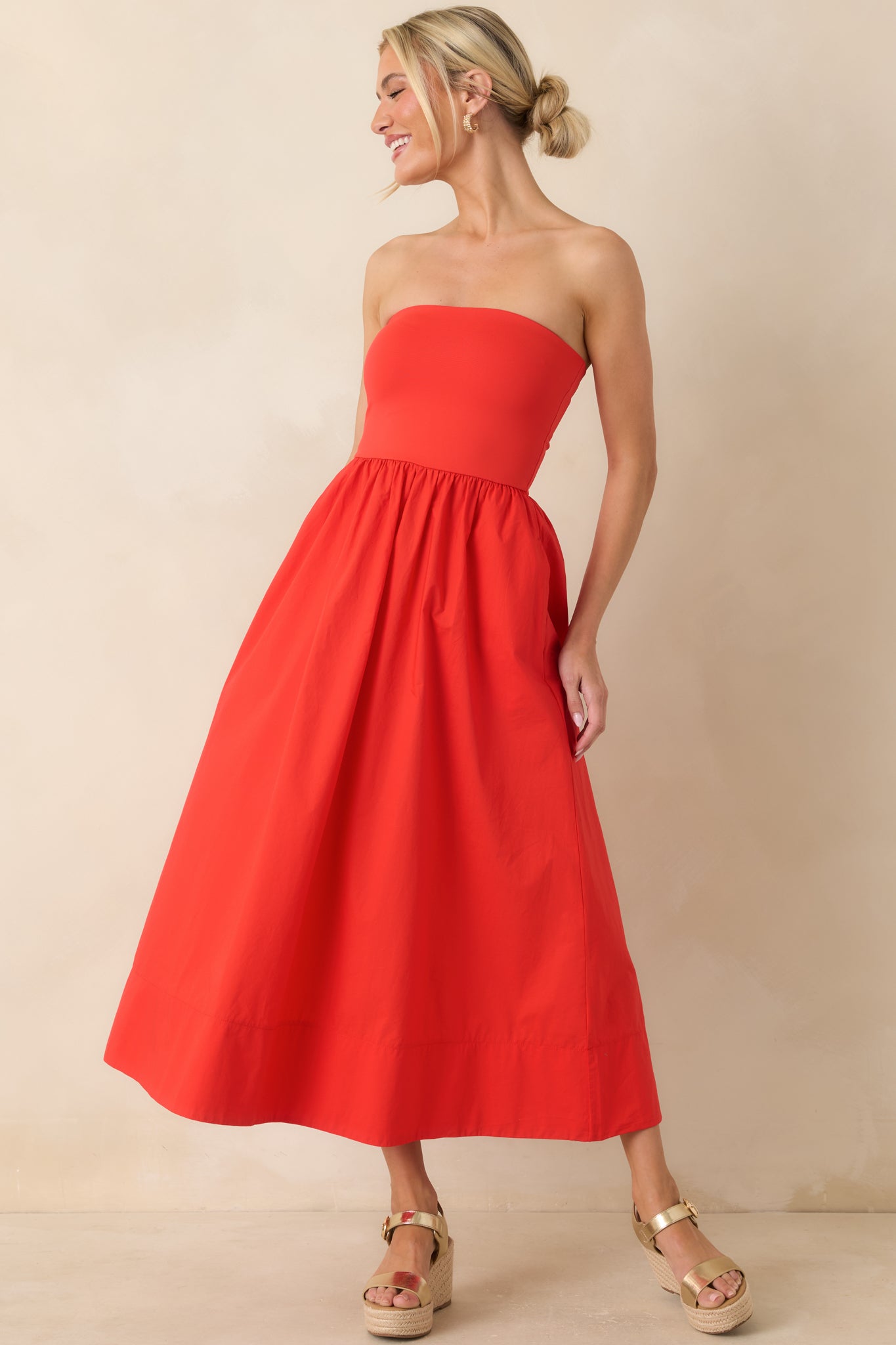 Front full view highlighting the structured strapless neckline and defined waist leading into a relaxed midi-length skirt.