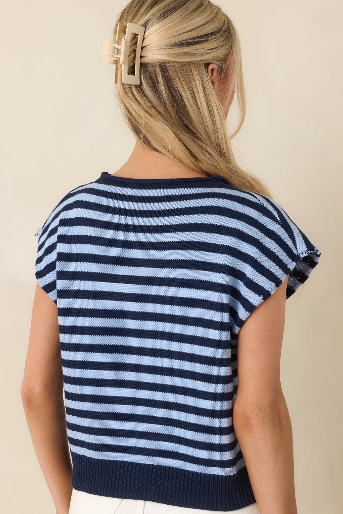 Rear view of striped knit top with collared neckline and cap sleeves.