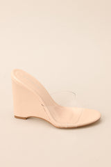 Outer-side view of these heels that feature a rounded toe, a clear strap over the top of the foot, and a wedged heel.