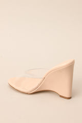Inner-side view of these heels that feature a rounded toe, a clear strap over the top of the foot, and a wedged heel.
