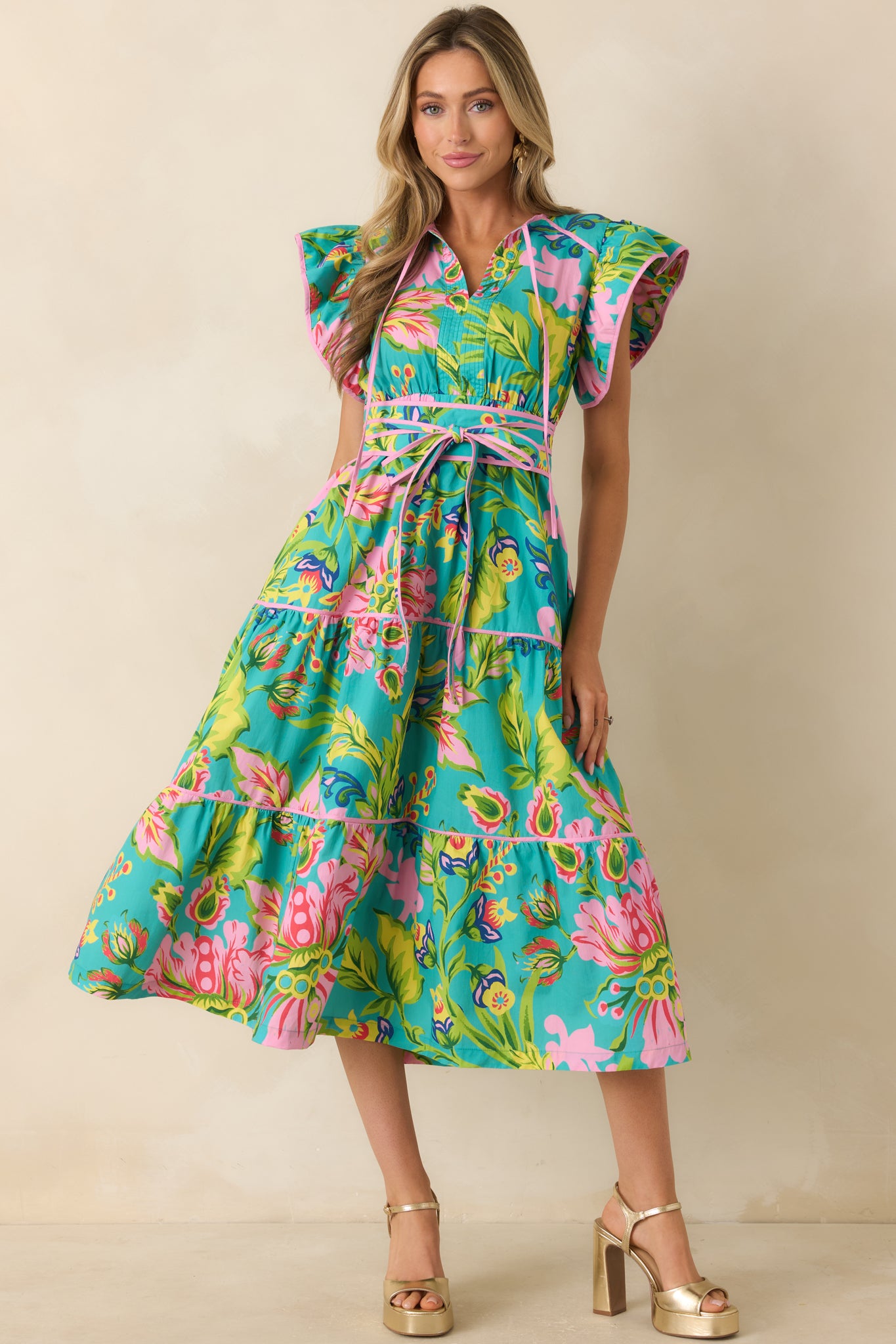 Tropical floral midi dress featuring flutter sleeves and a breezy tiered skirt for easy movement.