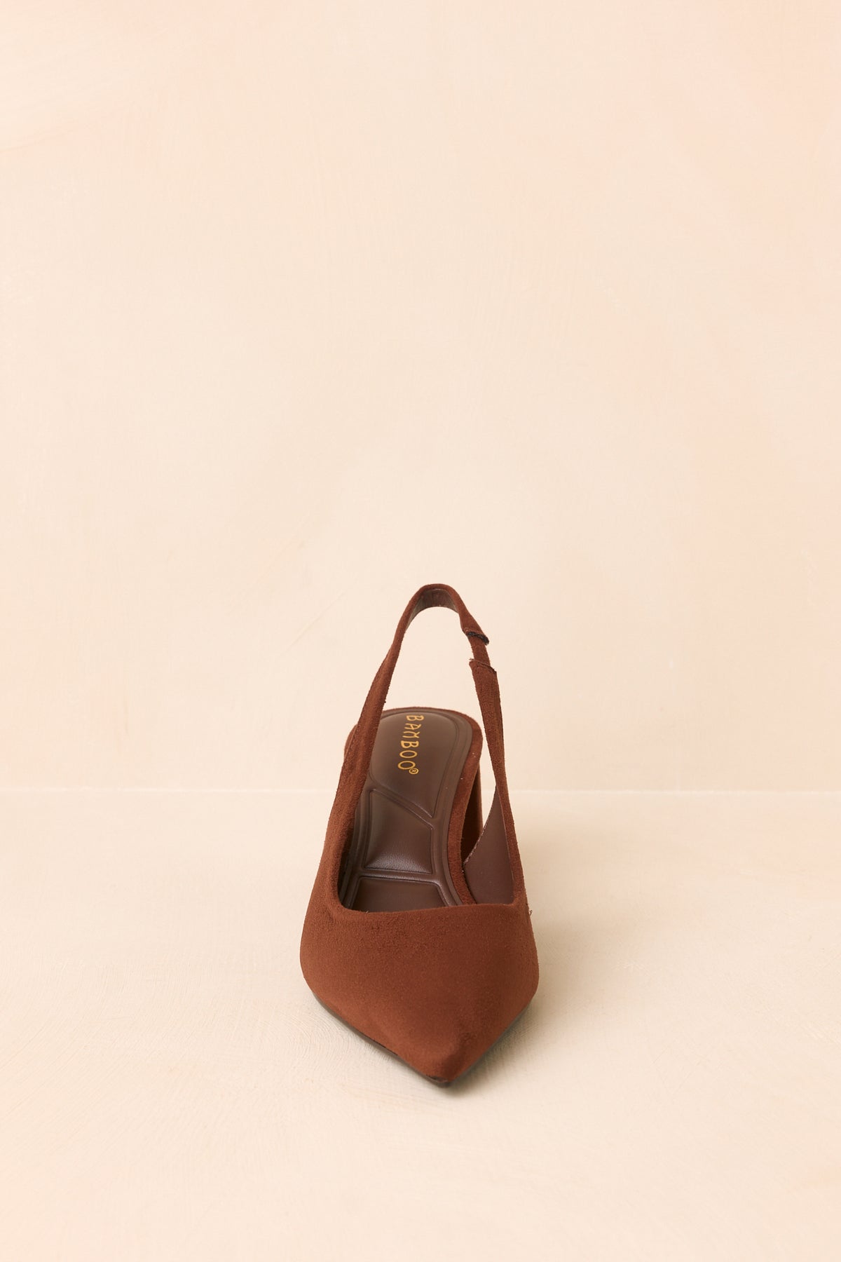 Warm brown heels highlighting the streamlined pointed-toe shape, textured faux suede upper, and slender slingback strap.