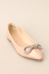 Angled front view of these flats that feature a pointed toe, a rhinestone embellished bow, and a shiny finish.