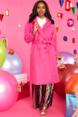 This pink coat features buttoned sleeve tabs, a double breasted buttoned closure, and an optional self-tie belt.