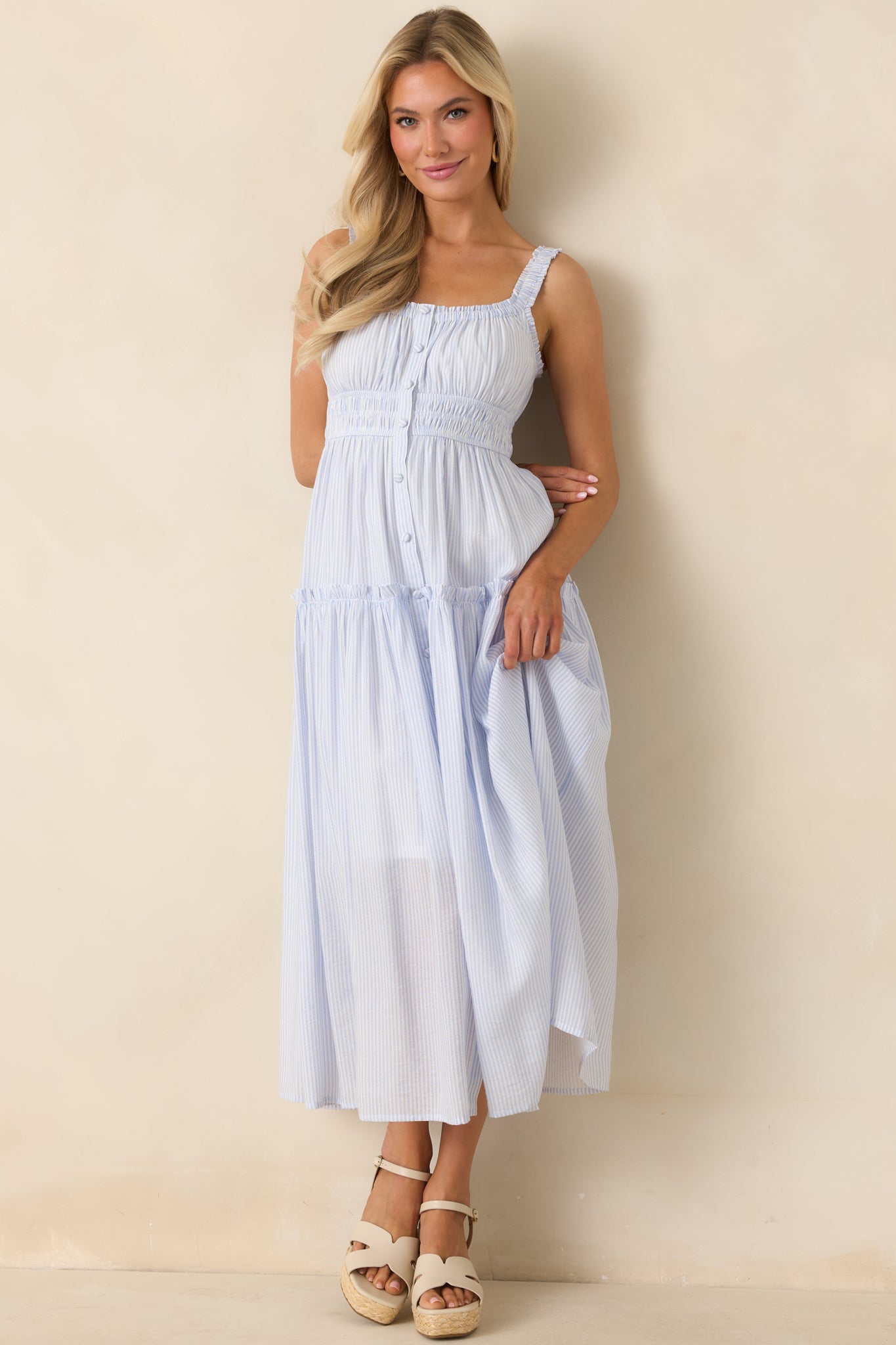 Lightweight pinstripe dress with a smocked waist, gathered neckline, and softly layered skirt.