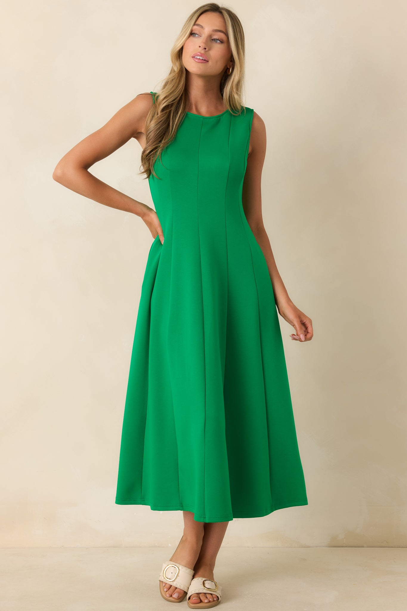 Soft green midi dress showcasing a relaxed silhouette, hidden side pockets, and a comfortable stretch fabrication.