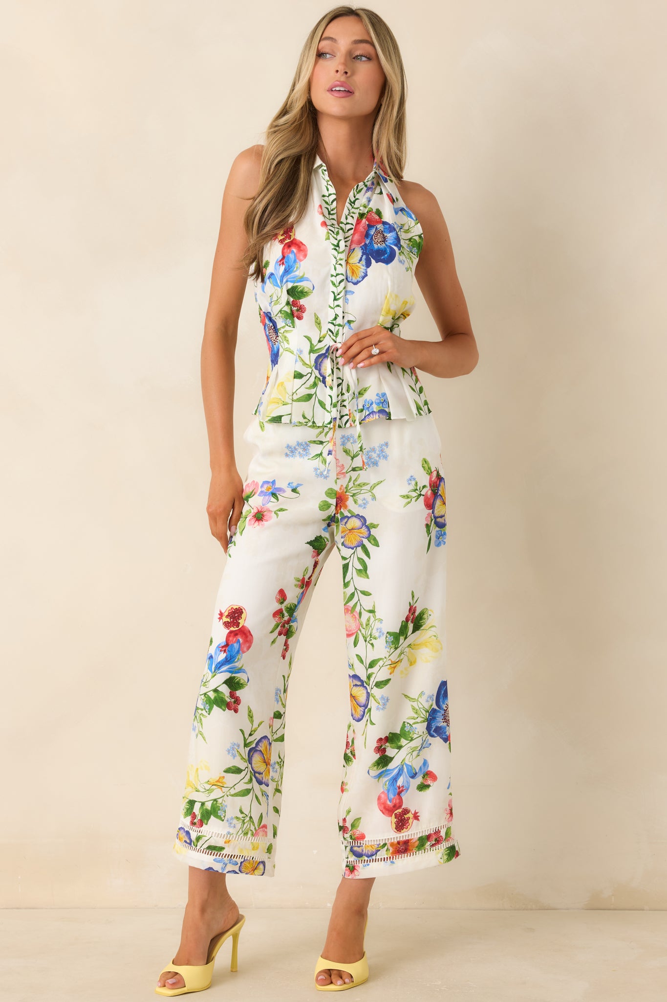 Botanical print halter top with soft ivory base and subtle front placket detail.