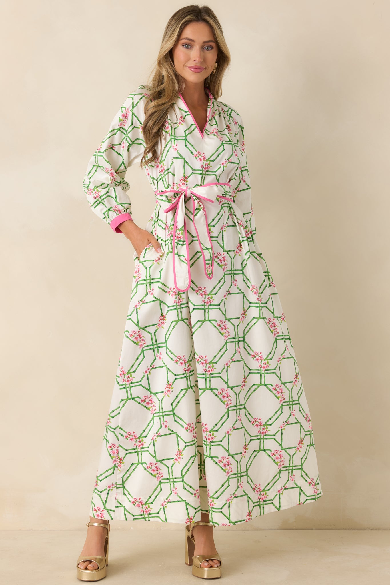 White maxi dress featuring contrast trim at the neckline and side pockets for a functional finish.