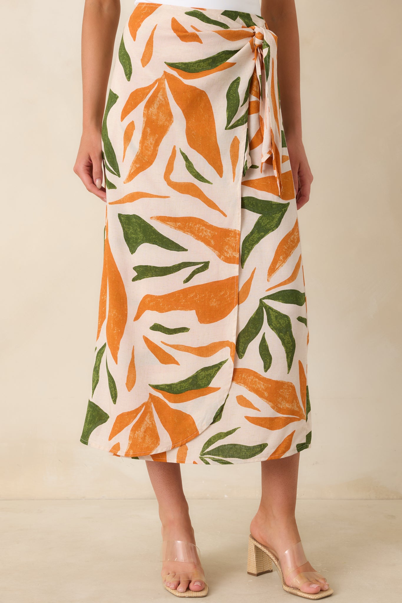 Orange and green tropical fabric showing lightweight texture and wrap construction.