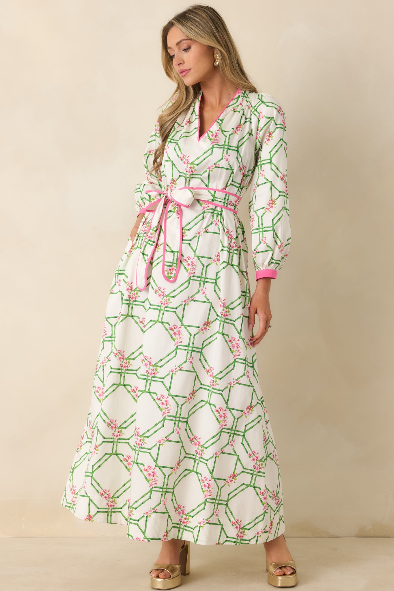Pink and green printed cotton dress with a fluid silhouette and softly structured long sleeve design.