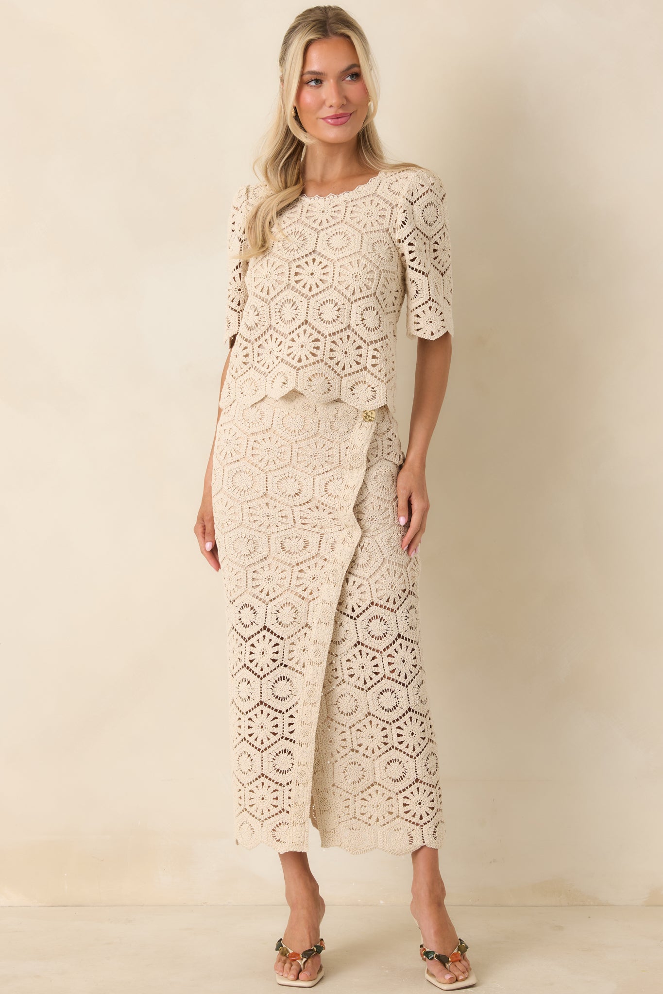 Fitted top with scalloped trim, short sleeves, and elevated lace design.