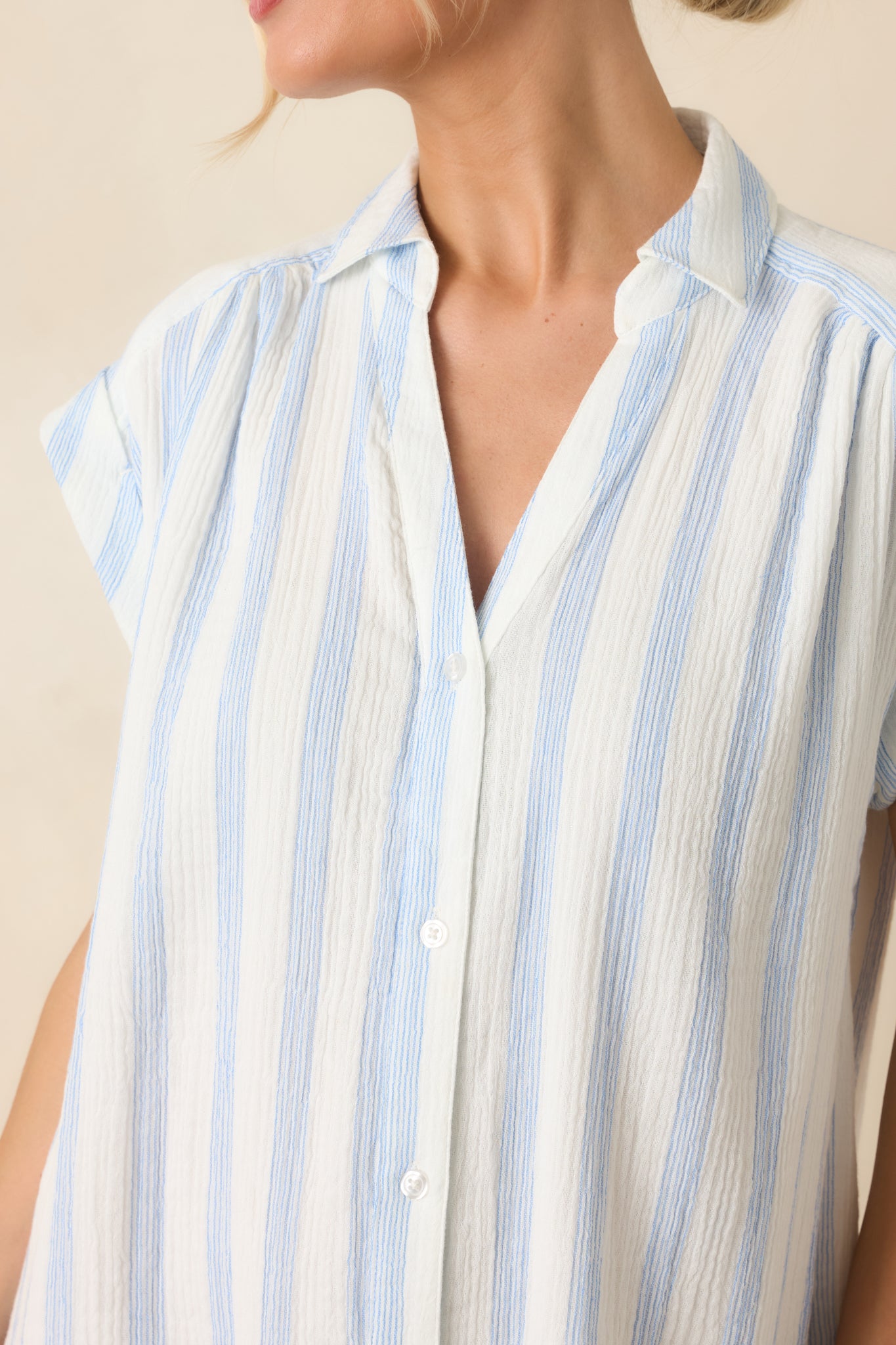 Close-up of the cotton gauze fabric showing its lightweight texture and woven ivory and blue stripe pattern.