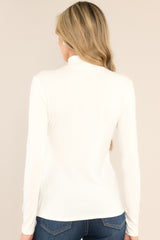 Back view of  this top that features a turtle neckline, a soft & lightweight material, a timeless design, and long sleeves.